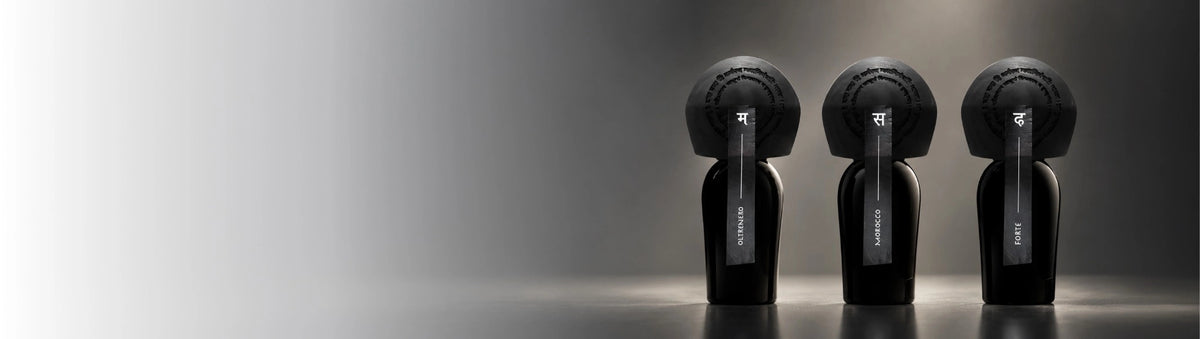 Rajani perfume bottles Oltrenero, Morocco and Forte, black with round black caps and tags, on a dark gray background